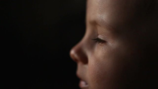 Captivated baby lost at television, TV education, tired boy portrait expression