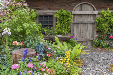 Fototapeta na wymiar Landscaped backyard of old house with flower garden