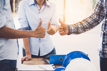Builder team meeting and approved planning for renovation office project. worker contractor talking with architect and discussing about job.