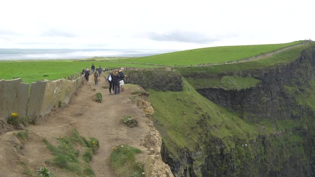 A group of people visiting  Cliffs of Moher