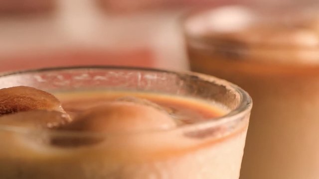 Iced coffee in glass jars on the table.