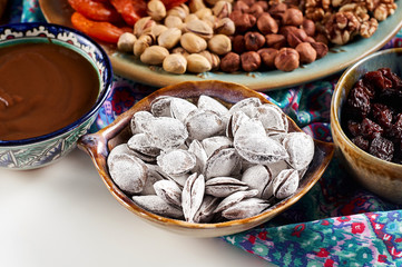 Traditional Azerbaijan sweet cuisine of holiday Nowruz: apricot bones fried with salt, assortment of nuts and dry fruits