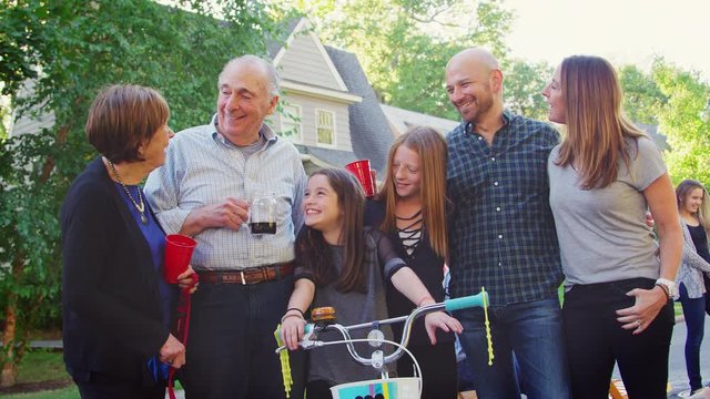 Group of neighbours smiling to camera at a block party