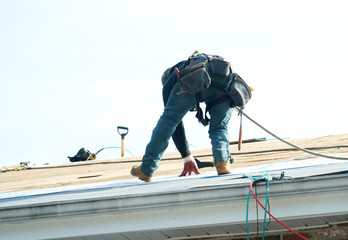 Handyman working on repairing the roof