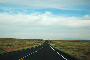 Straight country road extending in the land