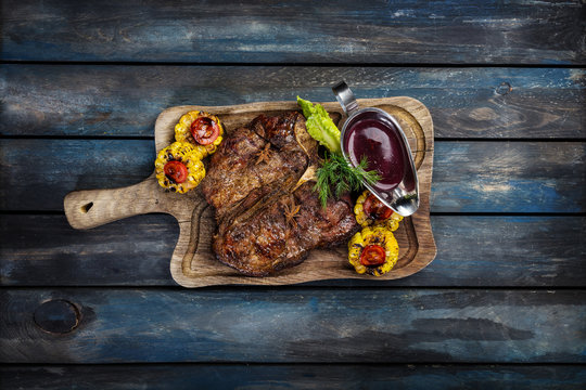steak fried tibon with corn and wine sauce on the table.