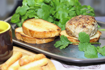 Food, lunch. Meat cutlet with toast, cilantro and parsley on a plate.