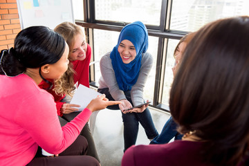Casual multiethnic women meeting for social project