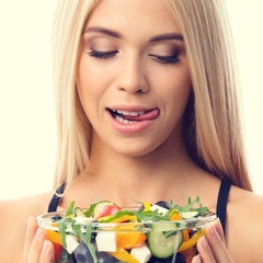 Woman in sportswear with salad