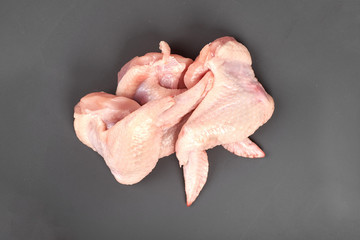 Raw chicken wings isolated on gray background