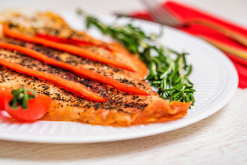 Roasted fish fillet with vegetables close