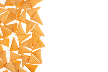 Corn snack in the shape of horn as decorative border isolated on white background. Top view.