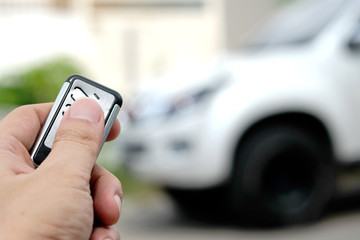 Man hand car remote control car door open.Technology concept And travel