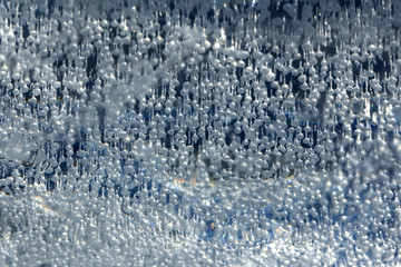 Naklejka na ściany i meble Abstract background. Bubbles of air frozen in ice. Fabulous texture.