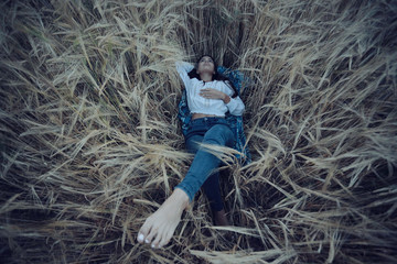 Dreaming in a wheaten field beautiful young adult woman