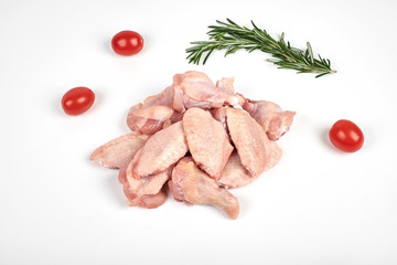 Raw chicken wings, tomatoes and rosemary isolated on white background