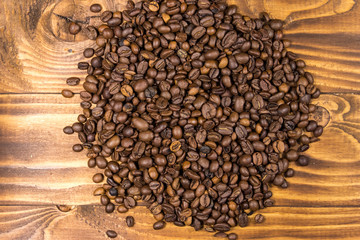 Roasted coffee beans on wooden background