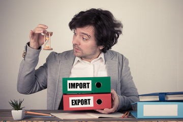 Import and Export text on the binders, worried bussinesman thinking by the work desk
