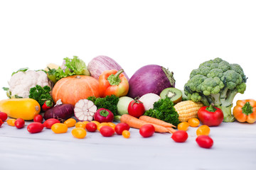 Fresh vegetables on wooden table. Isolated.
