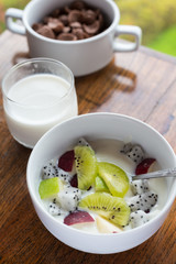 Breakfast, yogurt with fruit apples kiwi top view