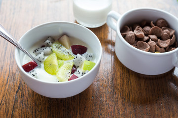 Breakfast, yogurt with fruit apples kiwi top view