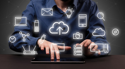 Businessman in suit typing with multimedia concept