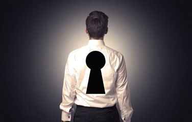 Man standing with black keyhole on his back