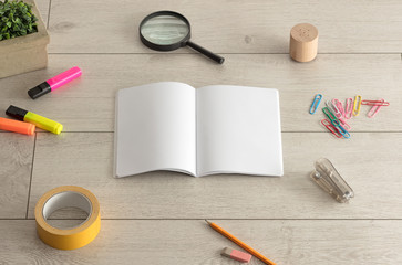 Notebook on the floor with office tools nearby