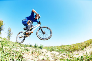 cyclist riding jumping with bicycle cross-country