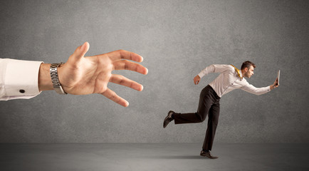Businessman running from hand