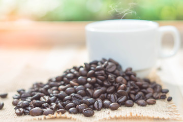 Coffee cup and coffee beans on table