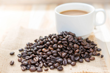 Coffee cup and coffee beans on table