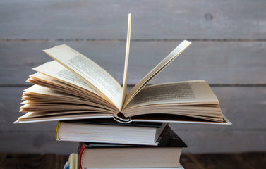 open book on a pile of books