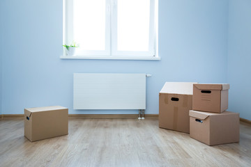 Cardboard boxes on laminate floor in empty room