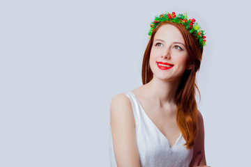 Portrait of a young redhead girl with flowers wreath
