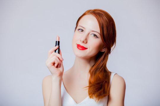 Young Redhead Girl Holding A Lipstick