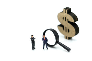 Miniature people: Magnifying glass focusing on the selected of businessman ,recruitment process, HR, HRM, HRD concepts.
