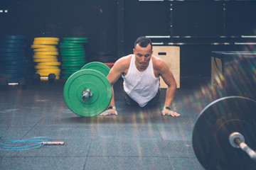 Man doing burpees over the bar