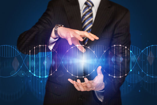Businessman holding DNA - Powered by Adobe