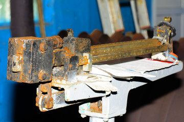 Old rusty scales for weighing weights at an abandoned and destroyed factory amidst chaos. Destruction and vandalism. Ukraine.