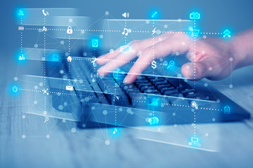 Hand pressing keyboard with high tech media icons