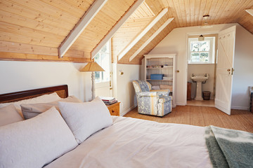 Spacious attic bedroom with bathroom in a home