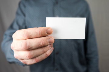 Businessman holding a business card. Mock up. Copy space.