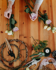 woman florist collects bouquet decorates different flowers