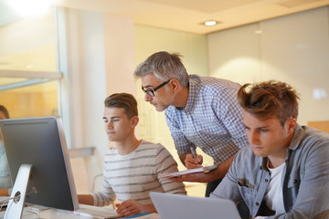 Students attending web design class with teacher