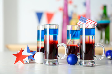 Layered cocktails in colors of American flag on table