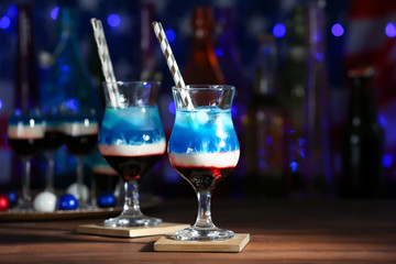 Layered cocktails in colors of American flag on table