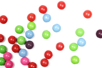 Colorful candies isolated on white background, top view