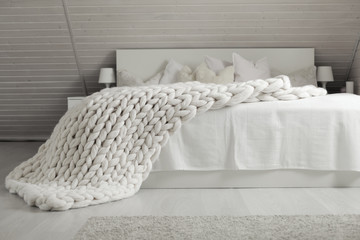 White nordic bedroom interior with knit plaid