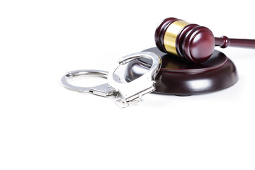 Wooden judge gavel and police handcuffs